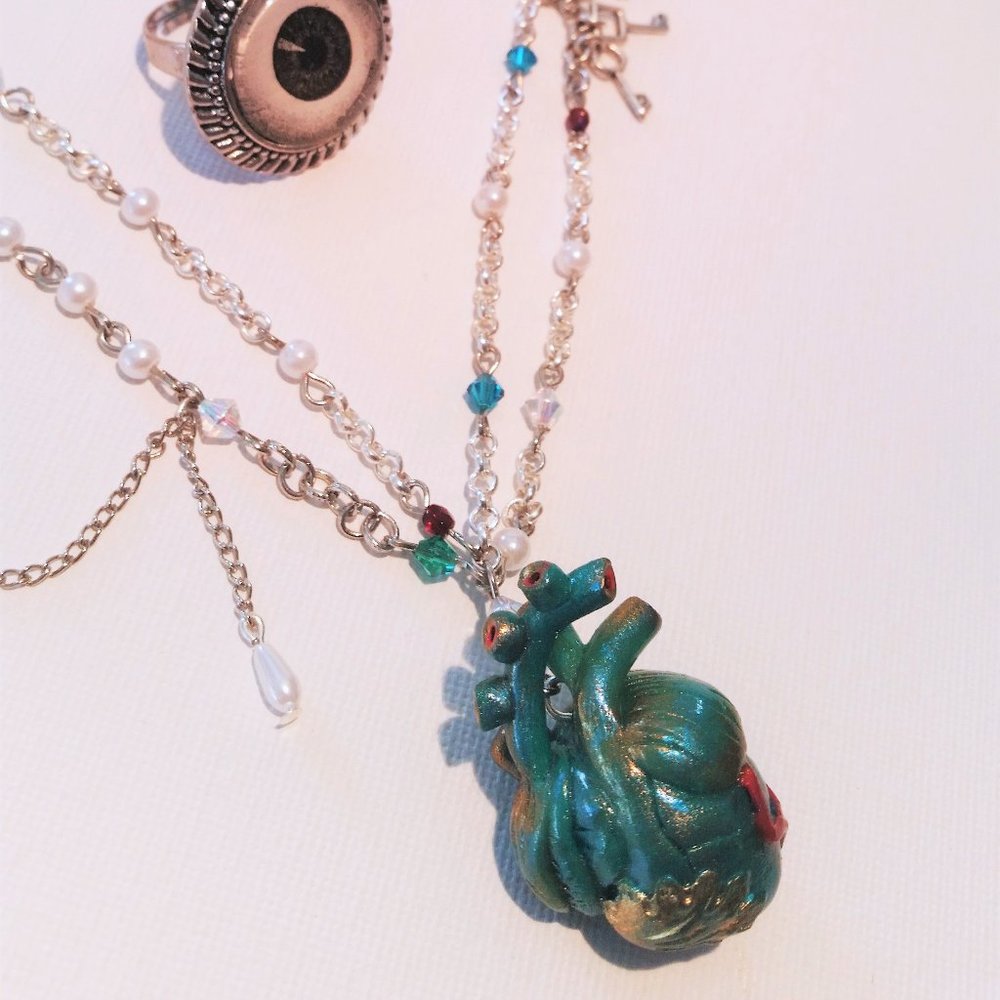 HANDMADE Mermaid's anatomical heart necklace filled with pearls.